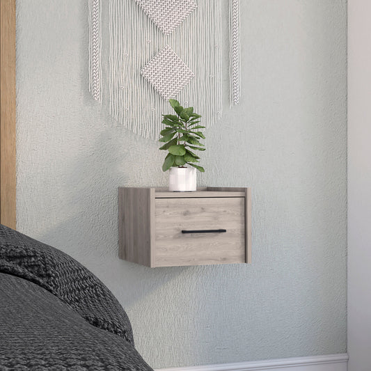 Grey wood floating nightstand with black handle and white potted plant