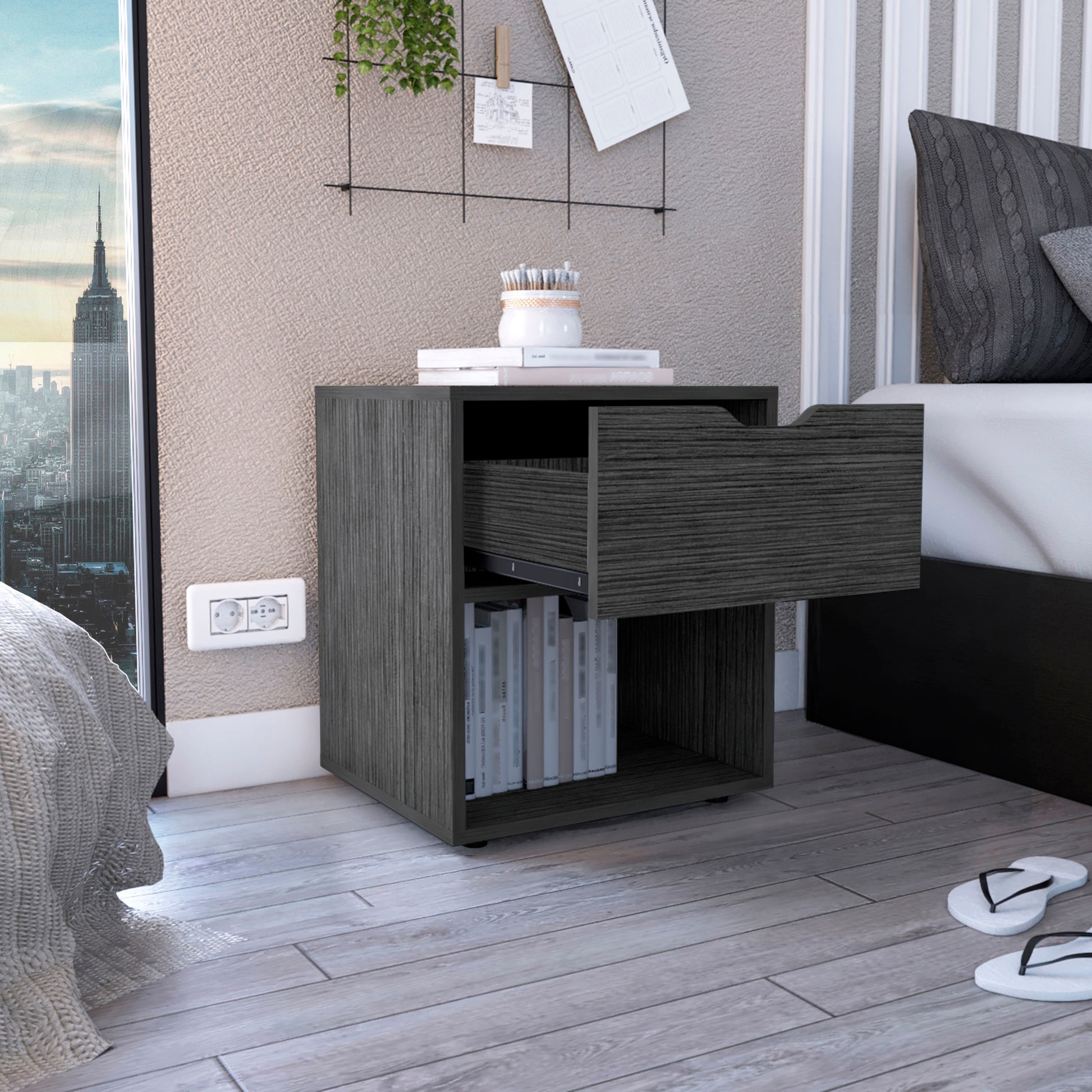 Dark wood bedside table with open drawer featuring a shelf with books