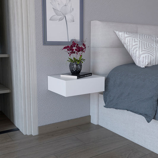 Floating white modern bedside table with books and a black vase with orchids