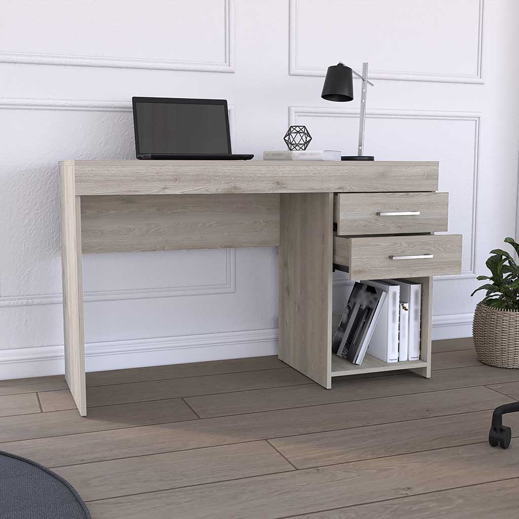 Light oak veneer desk with laptop lamp and books on shelves