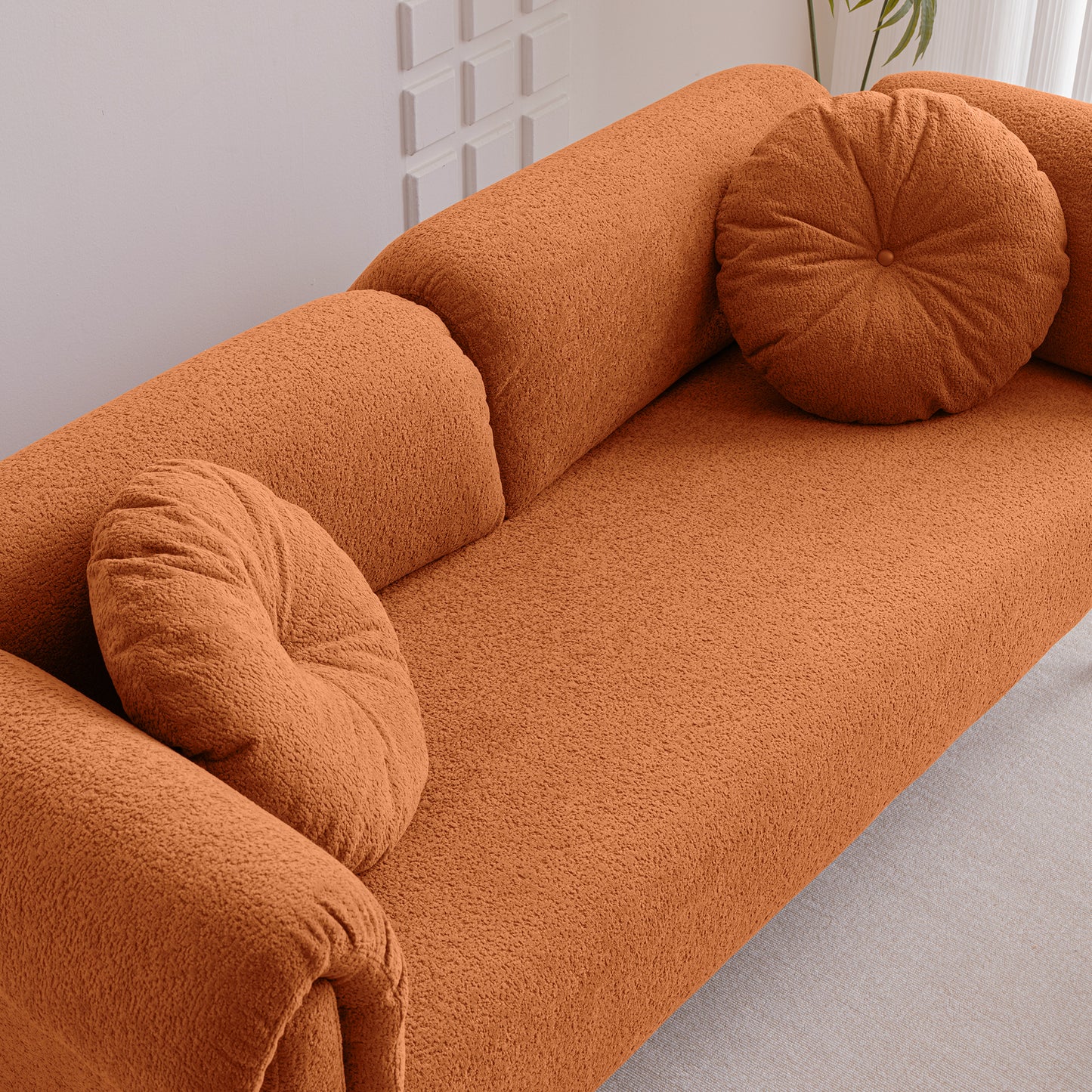 Burnt orange boucle fabric sofa with round decorative pillows modern living room furniture