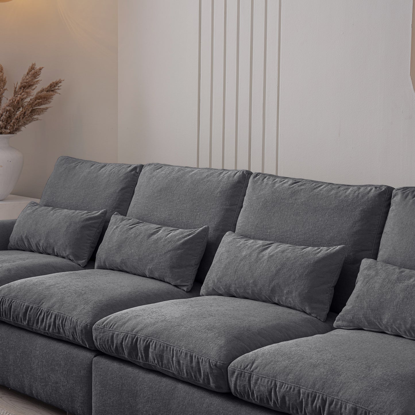 Plush grey sectional sofa with deep seat cushions and accent pillows