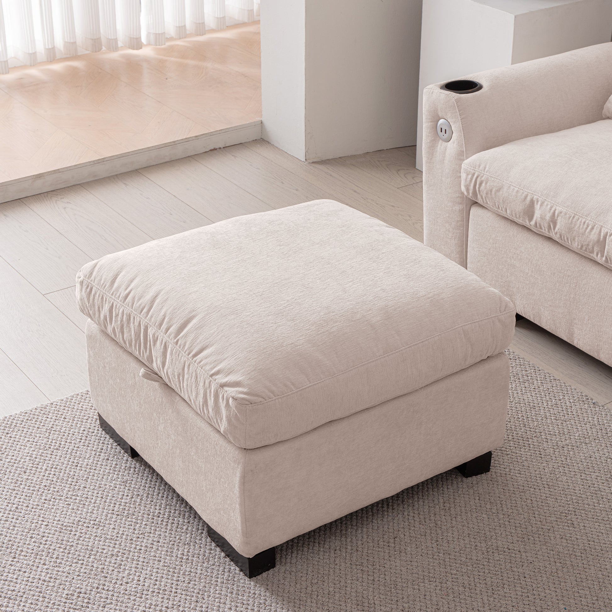 Plush beige fabric ottoman with a deep cushion perfect for footrest or extra seating