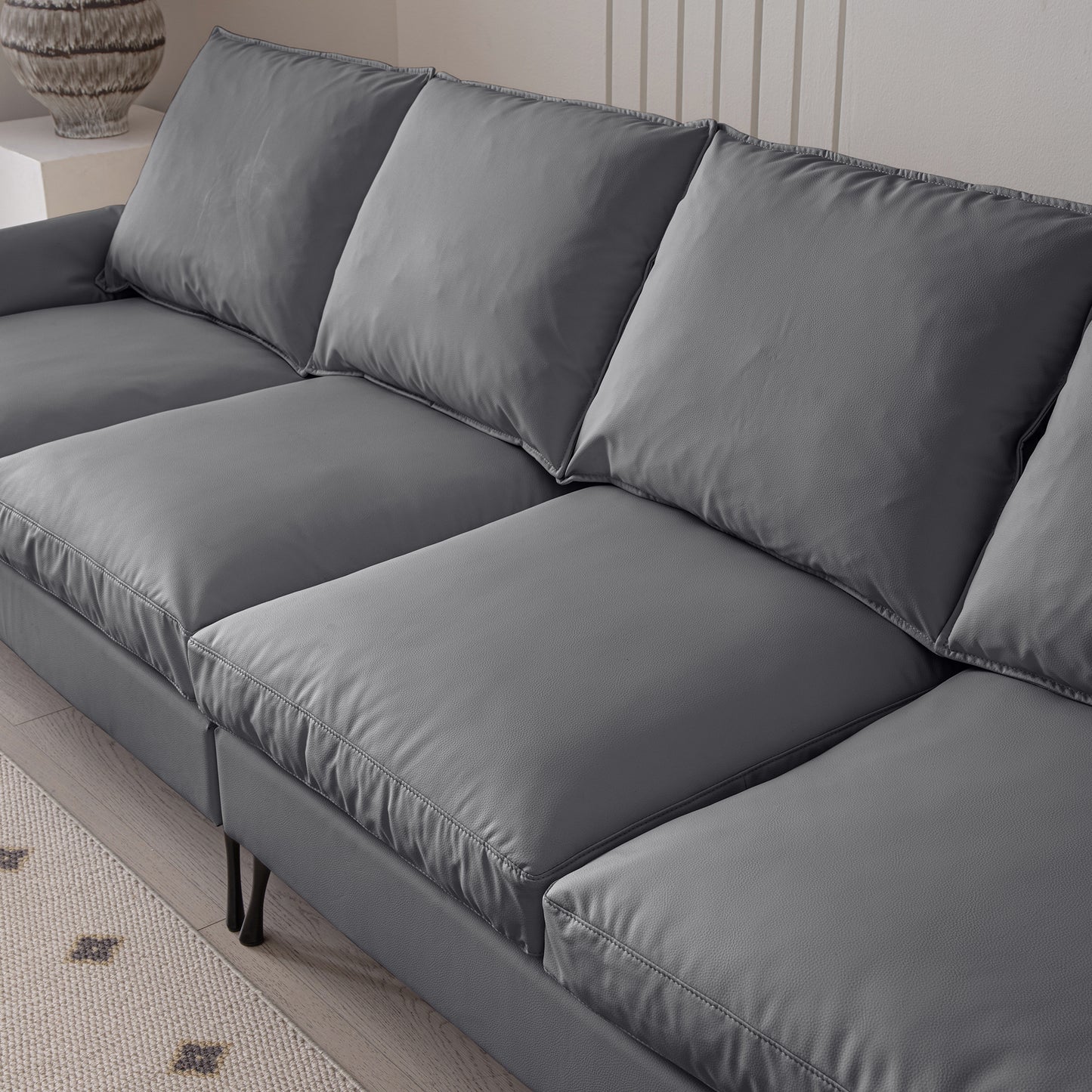 Modern charcoal grey leather sectional sofa with deep seating and plush cushions