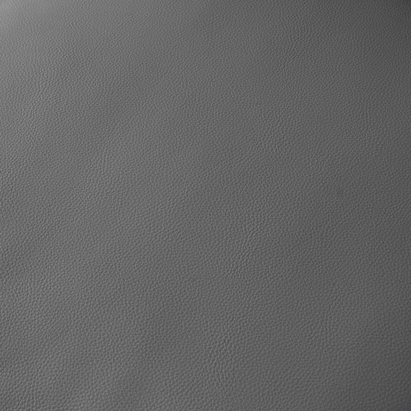 Closeup of textured grey leather material perfect for upholstery or fashion accessories