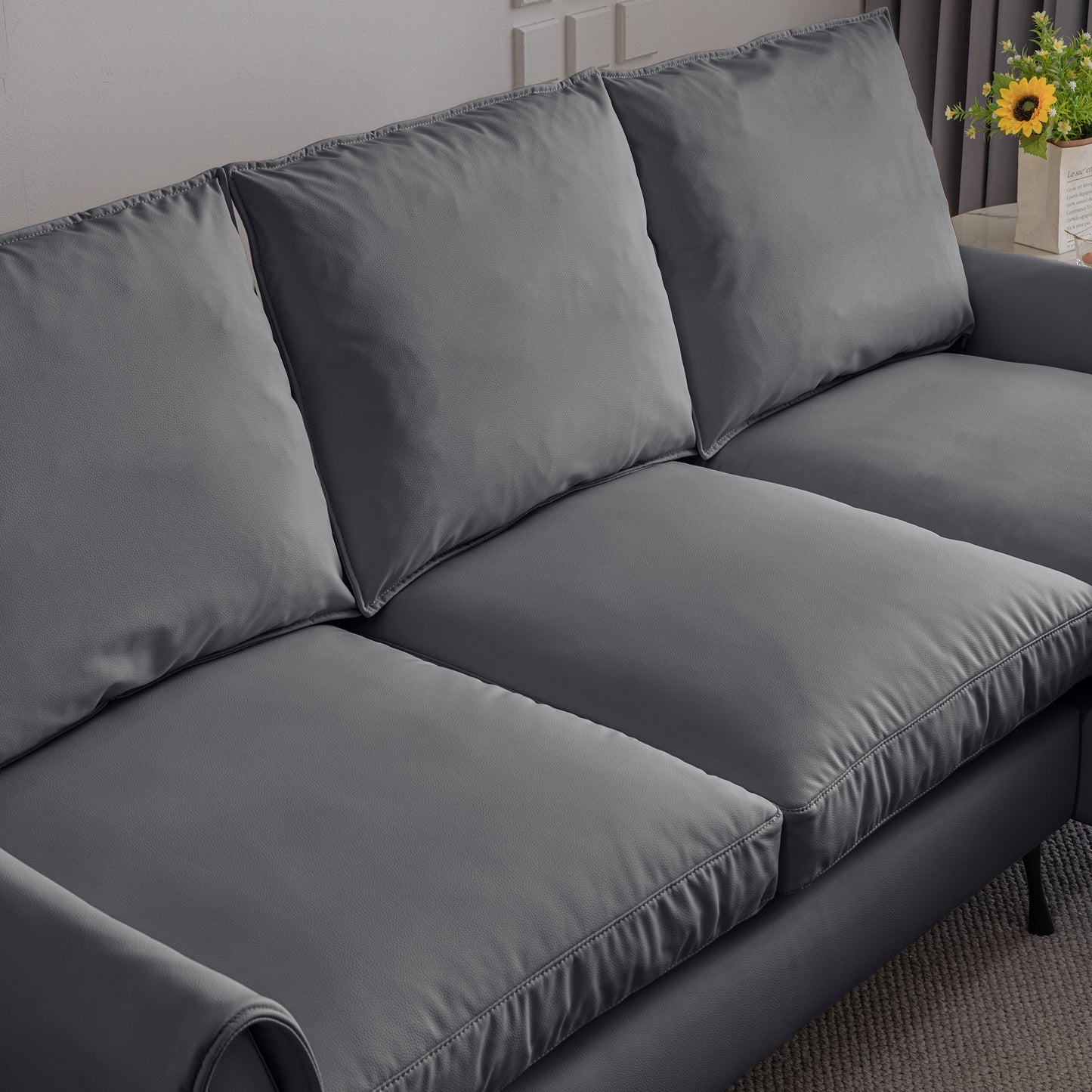 Closeup of a plush grey leather sectional sofa perfect for modern living rooms