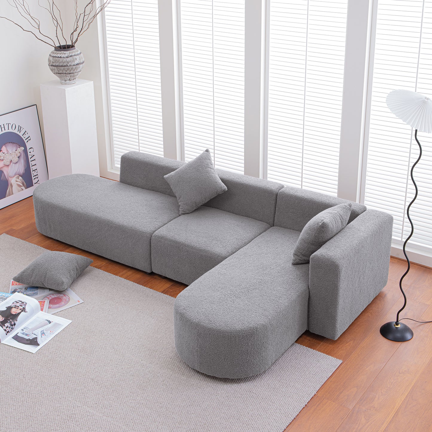 Plush grey modular sofa with rounded arms and removable cushions perfect for a modern living room