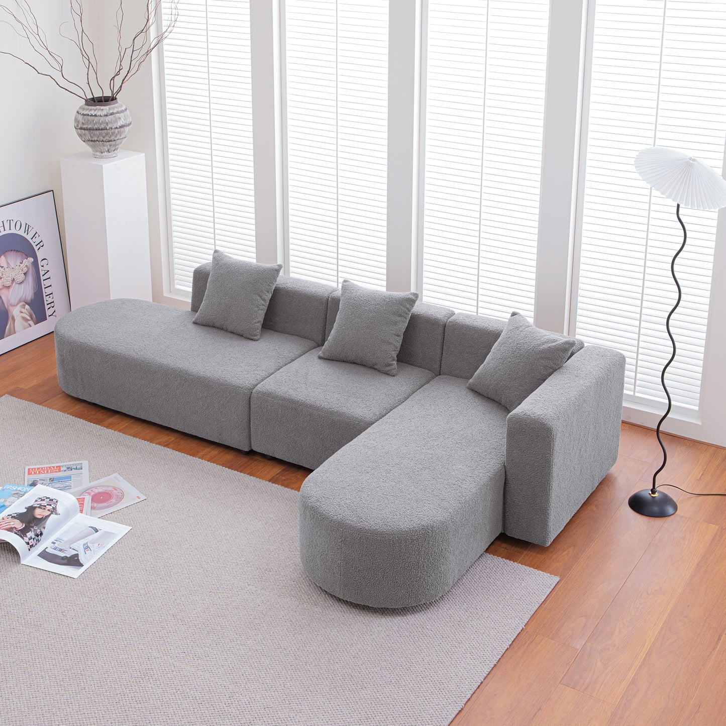 Plush grey sectional sofa with rounded chaise perfect for modern living rooms