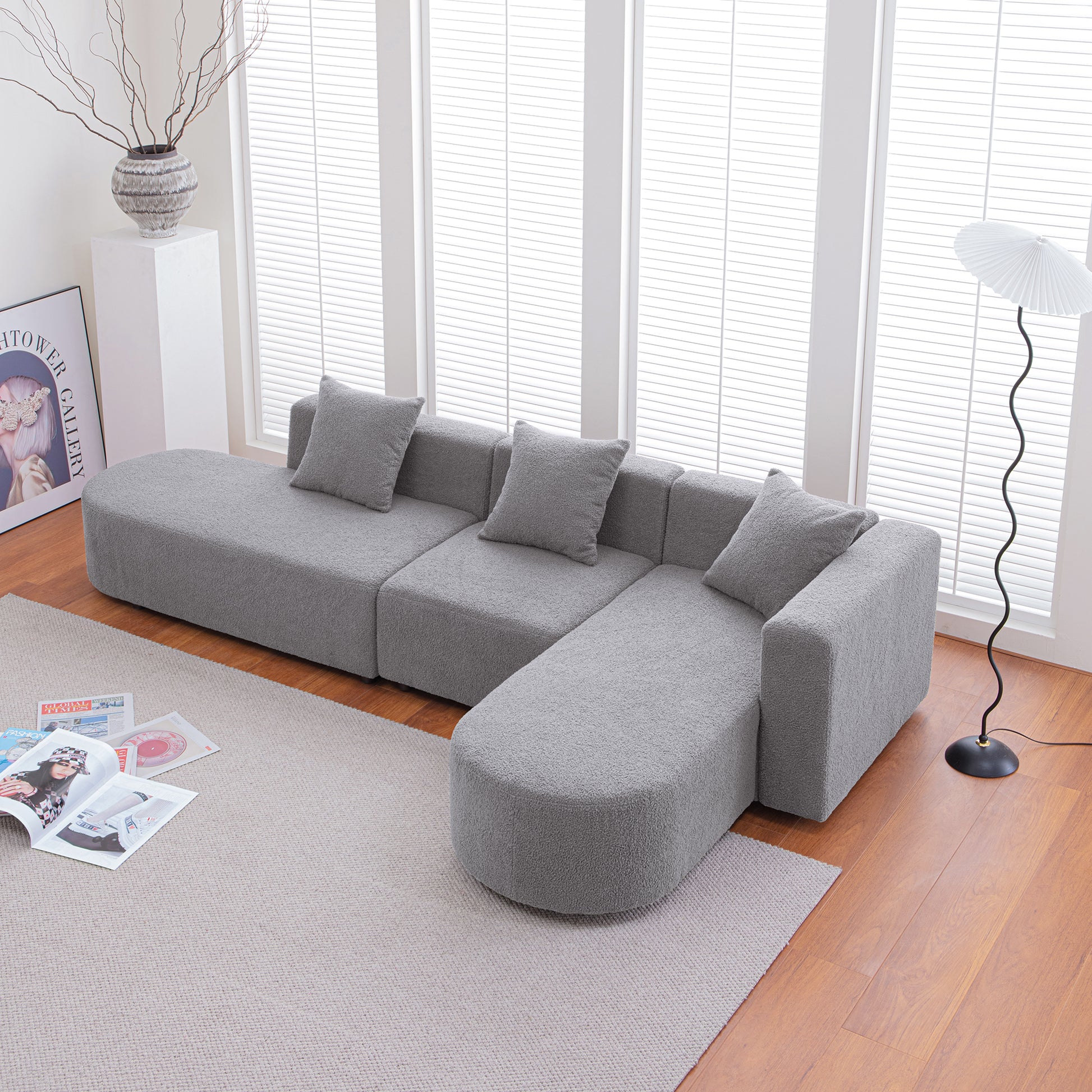 Plush grey sectional sofa with rounded chaise perfect for modern living rooms