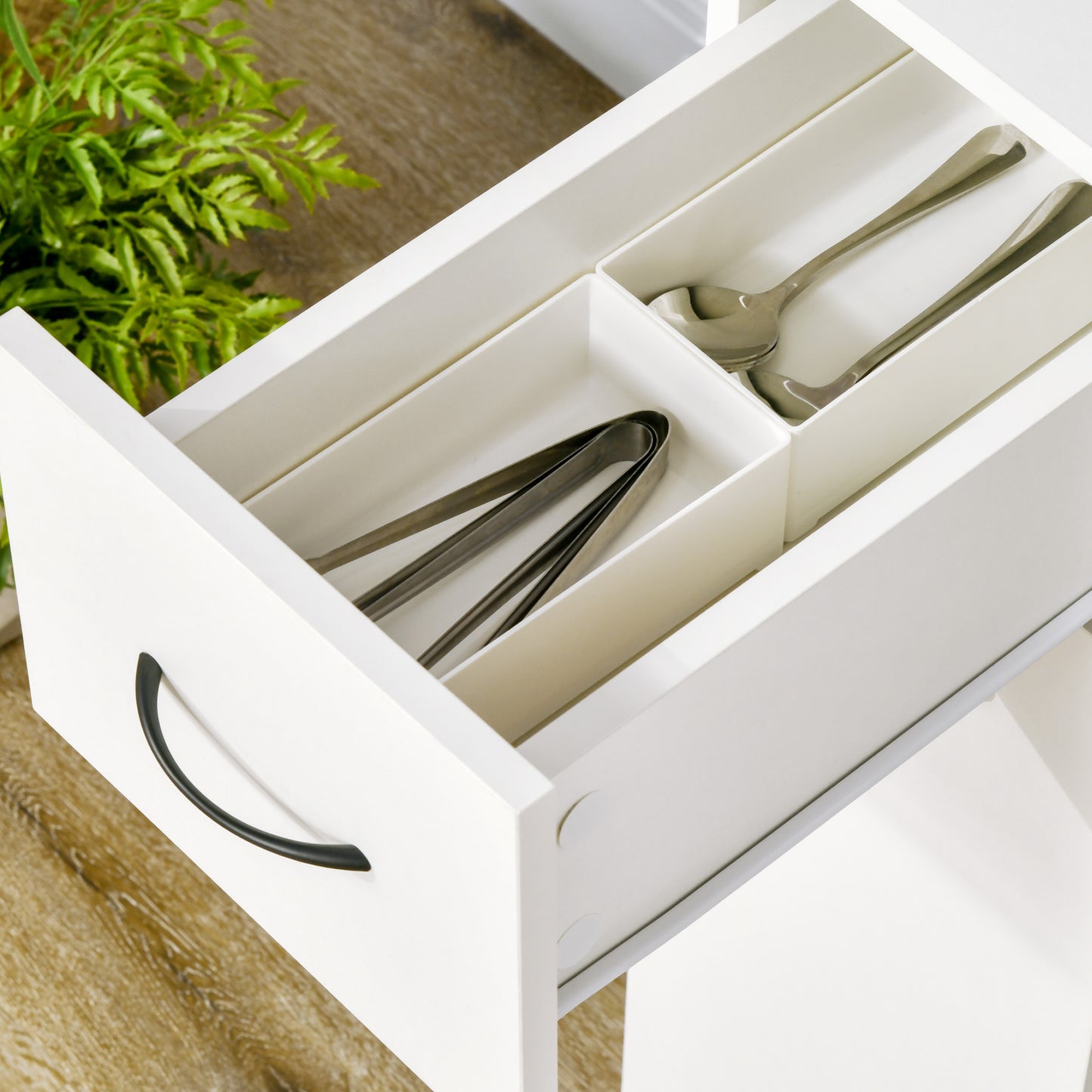 White drawer organizer with stainless steel serving spoons