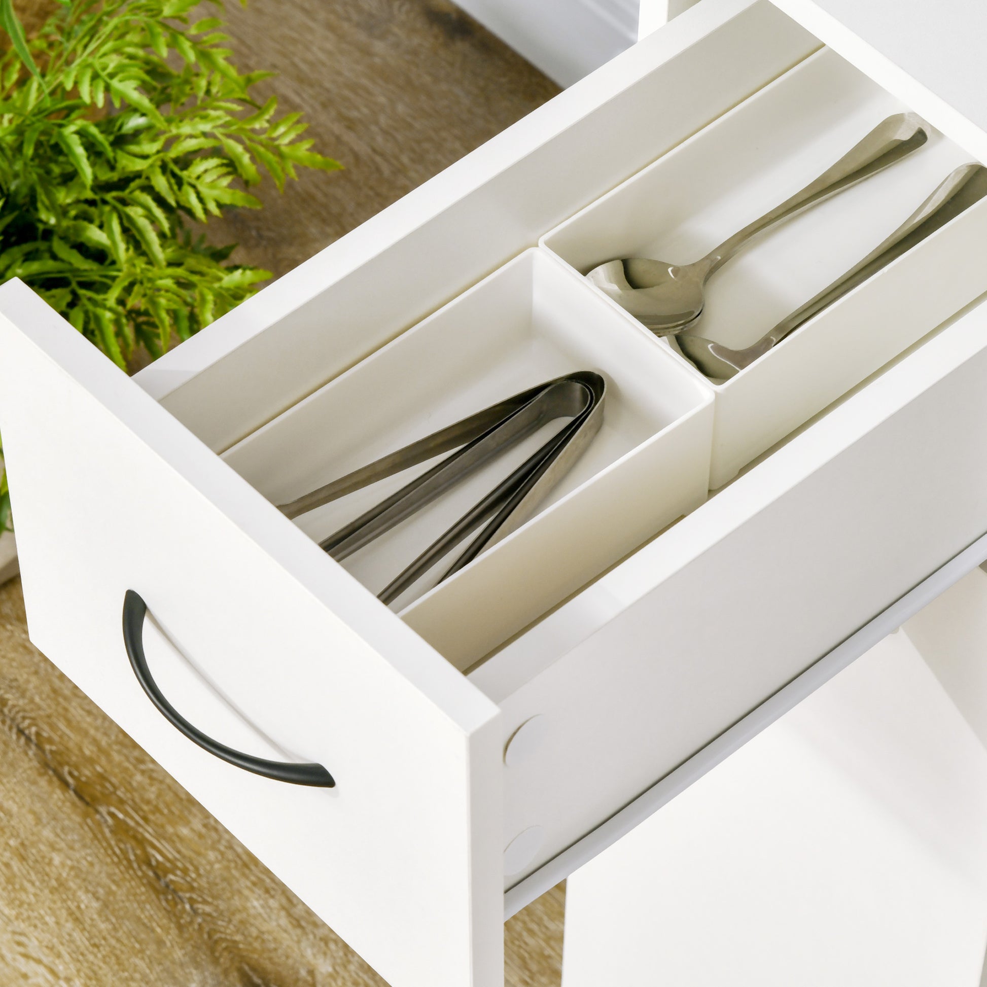 White drawer organizer with stainless steel serving spoons