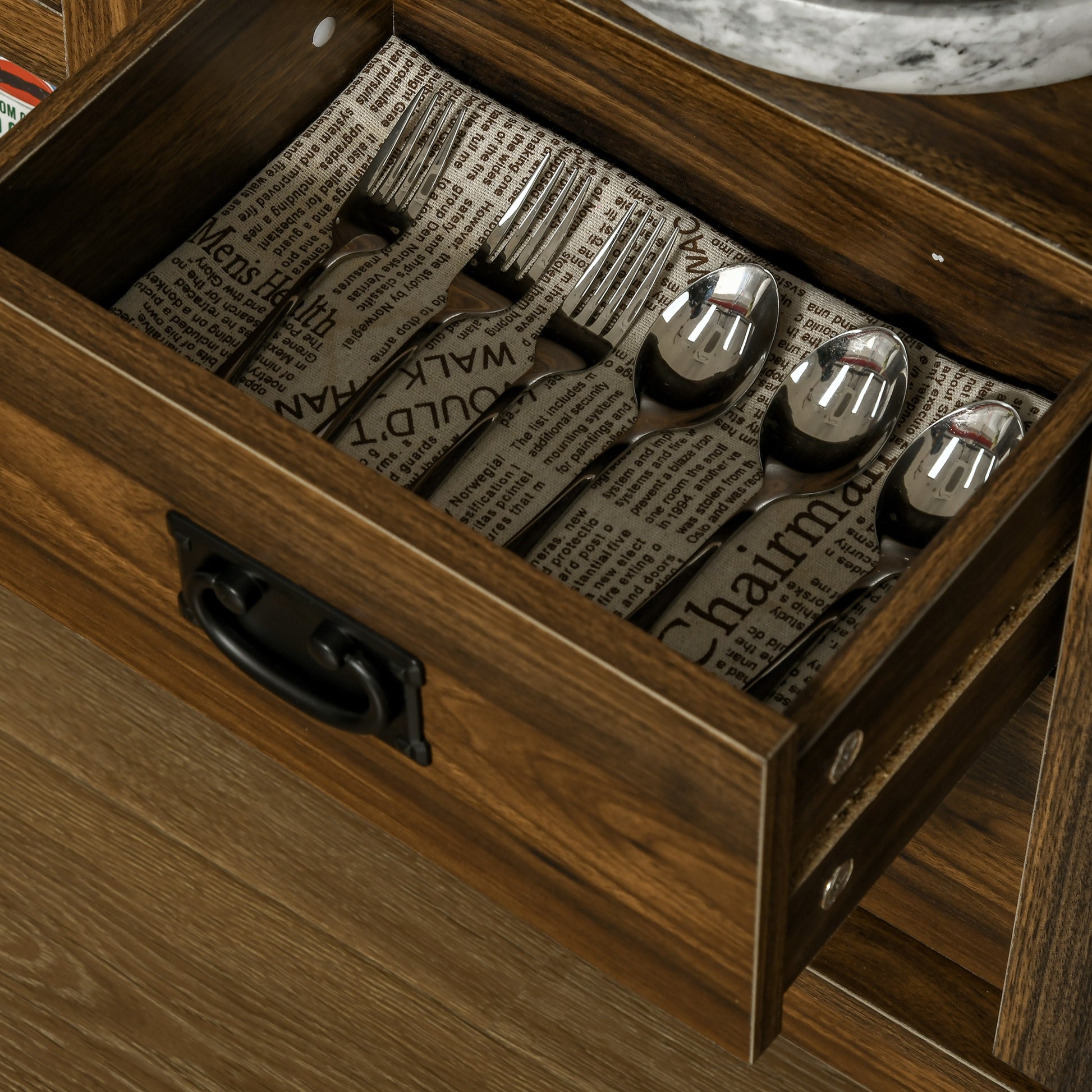 Stainless steel cutlery set with forks and spoons in a wooden drawer