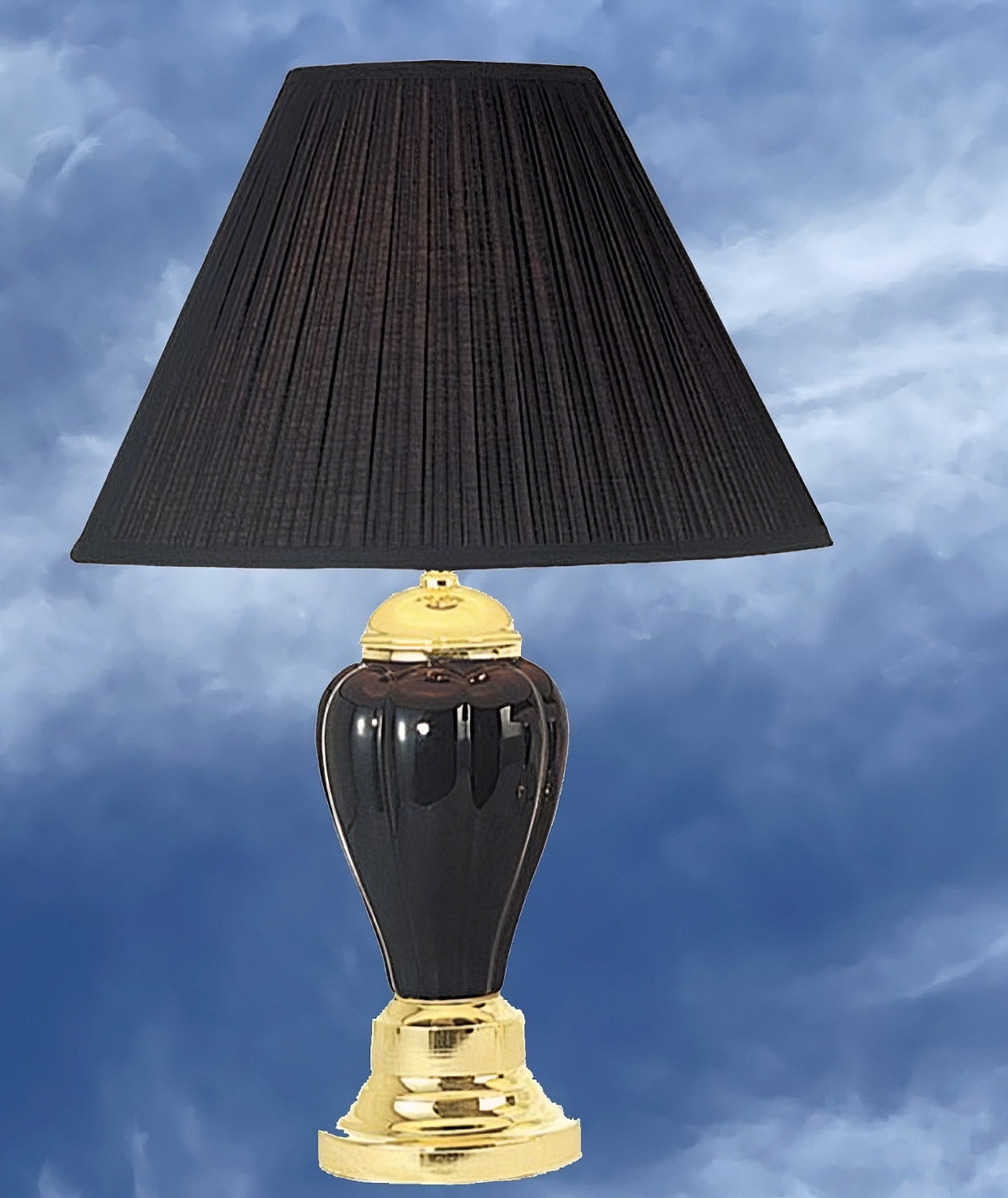 Elegant black pleated lampshade atop a glossy black ceramic and polished brass table lamp