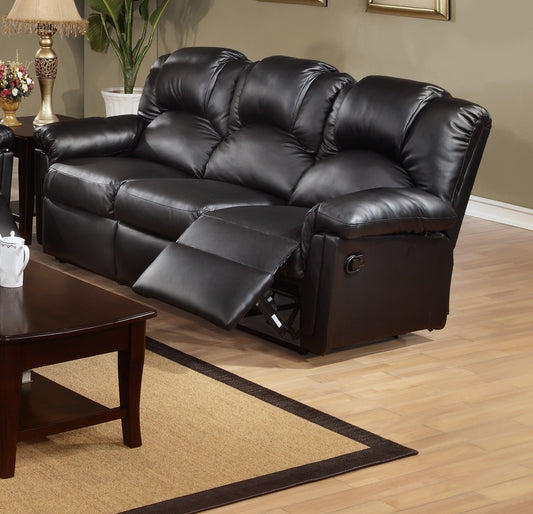 Plush black leather sofa with reclining footrest extended for ultimate comfort