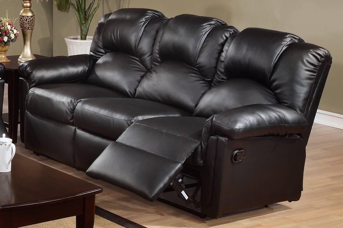 Black leather threeseater recliner sofa with padded cushions perfect for home theater seating