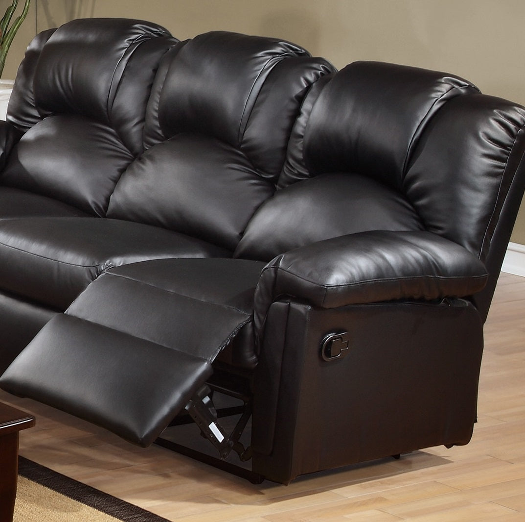 Black faux leather recliner sofa with plush cushioning and extended footrest