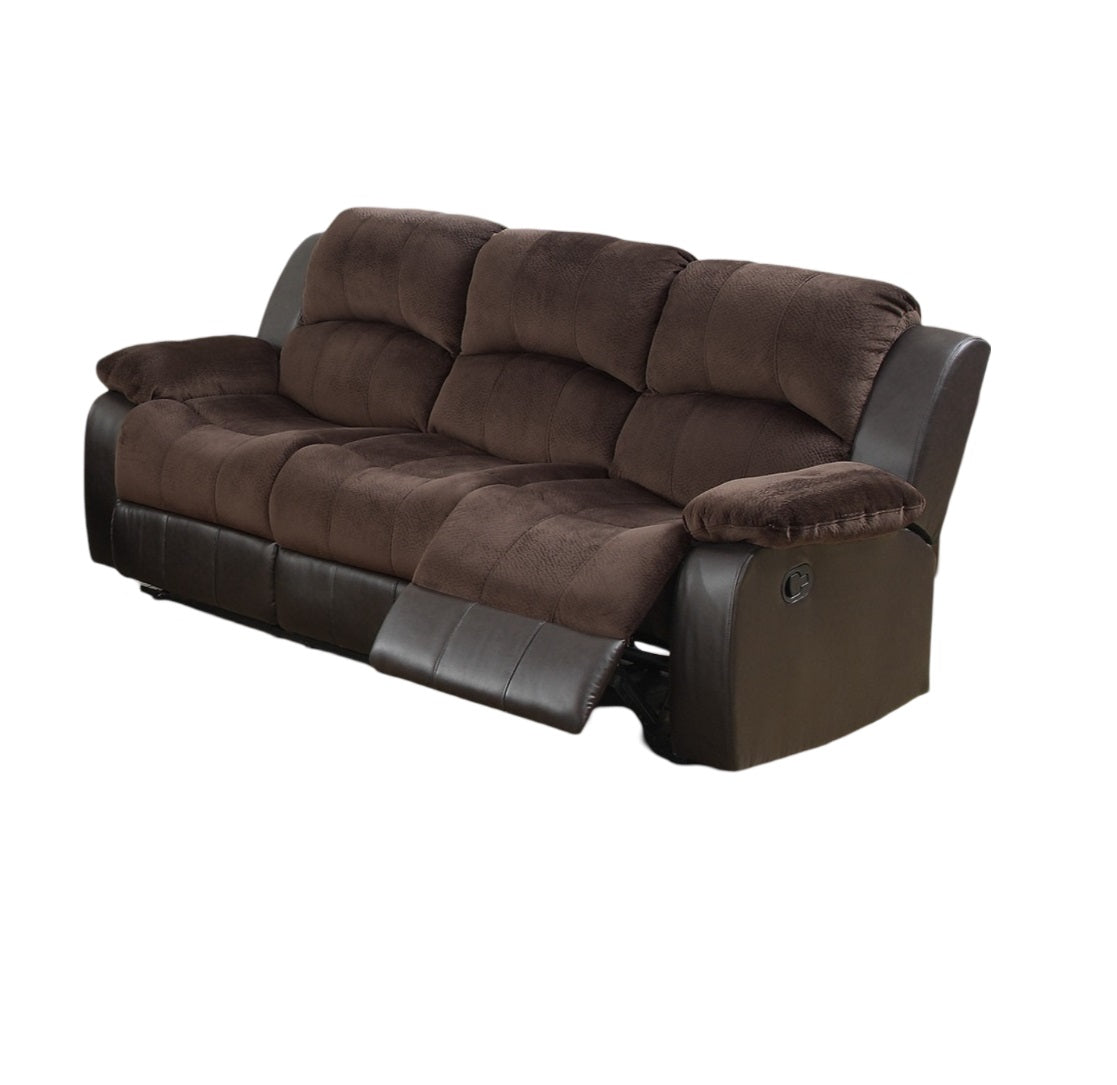 Brown fabric and faux leather reclining sofa with plush cushions
