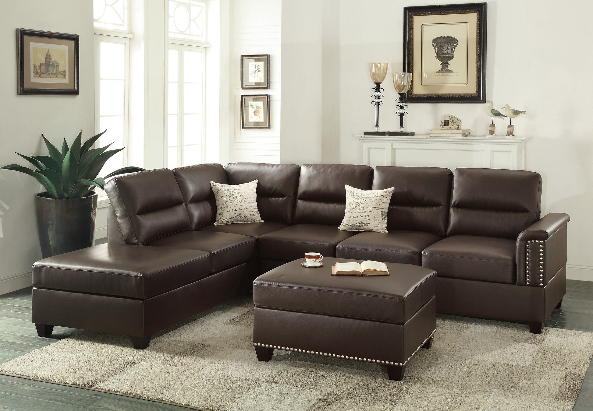 Rich brown leather sectional sofa with studded arms and matching ottoman in a living room setting