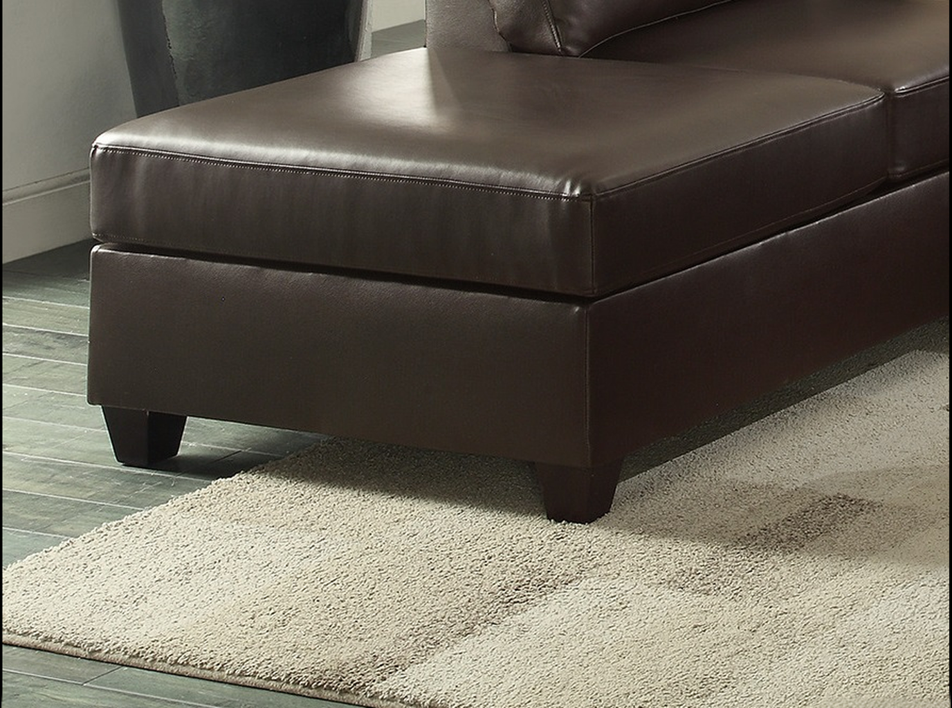 Brown faux leather chaise lounge ottoman with clean stitching
