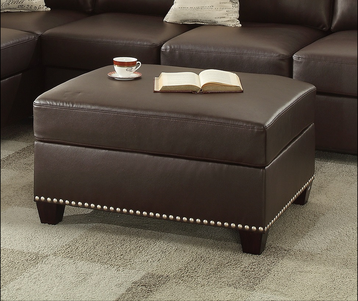 Brown faux leather storage ottoman with nailhead trim and wooden legs