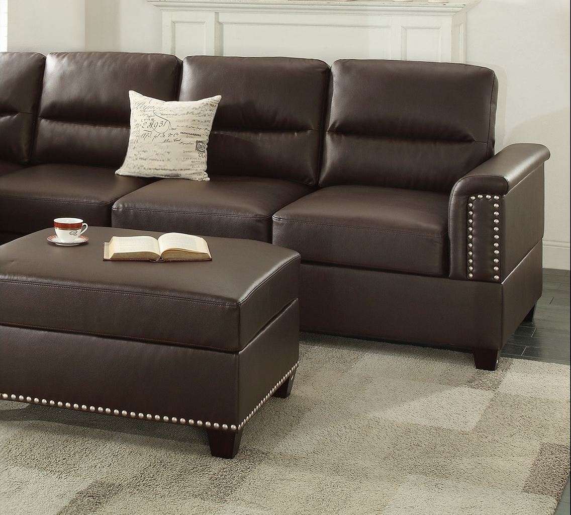 Dark brown leather sectional sofa with studded armrests and matching ottoman