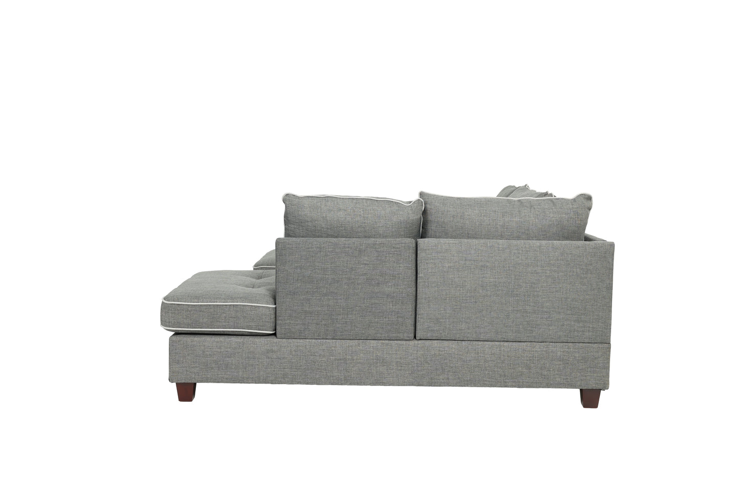 Grey fabric sectional sofa with white piping tufted seat cushion and dark wood legs