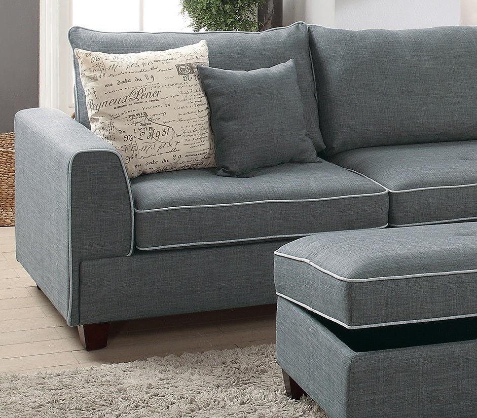 Gray fabric sectional sofa with white piping and decorative pillows