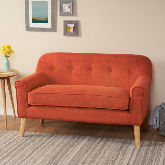 Orange upholstered accent chair with button tufting and wooden legs