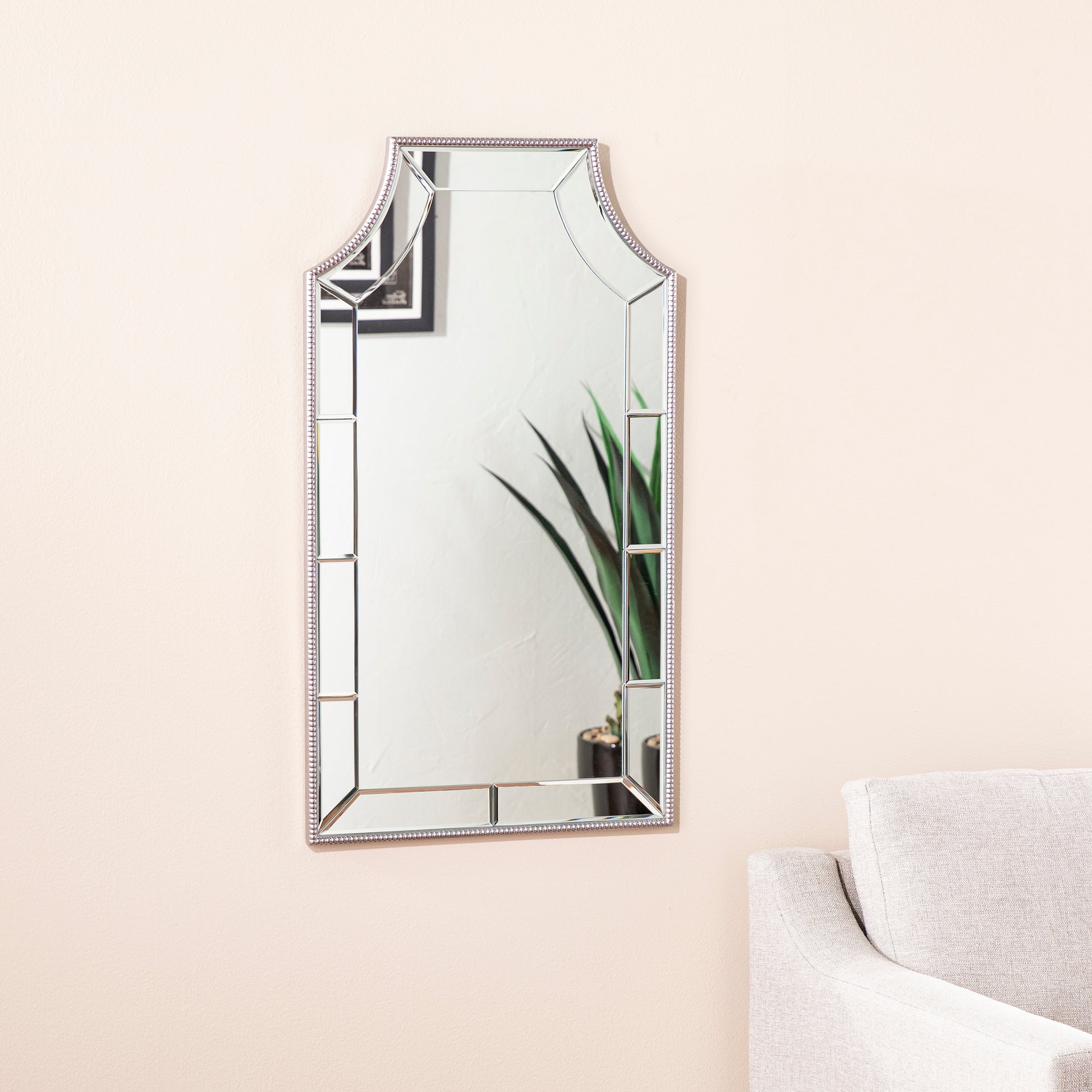 Decorative ornate mirror with silver beaded frame and beveled glass panels