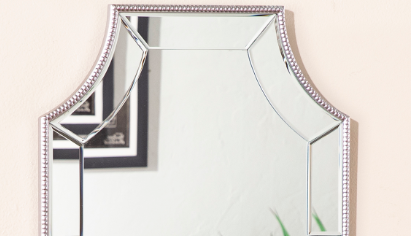 Ornate beveled mirror with silver bead trim perfect for an entryway accent wall