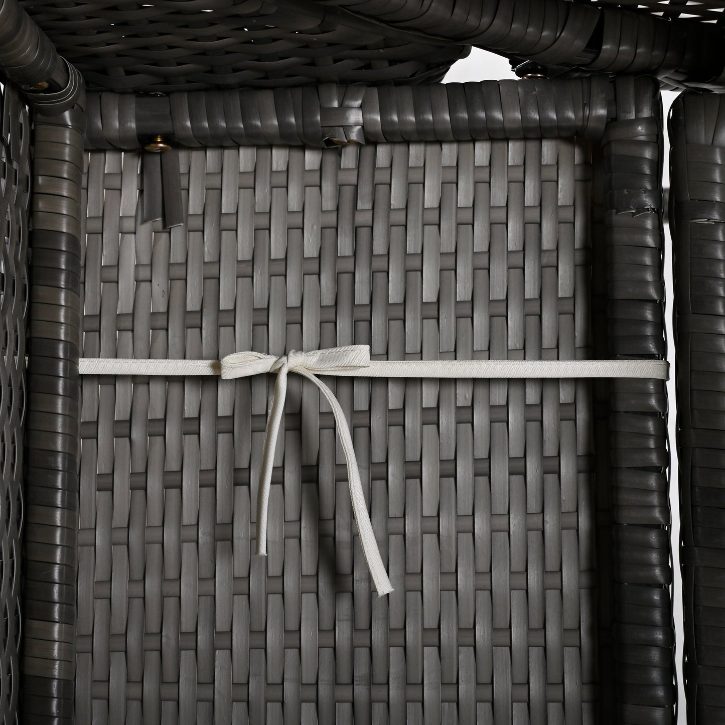 Closeup of grey rattan weave detail on outdoor furniture showing texture and construction