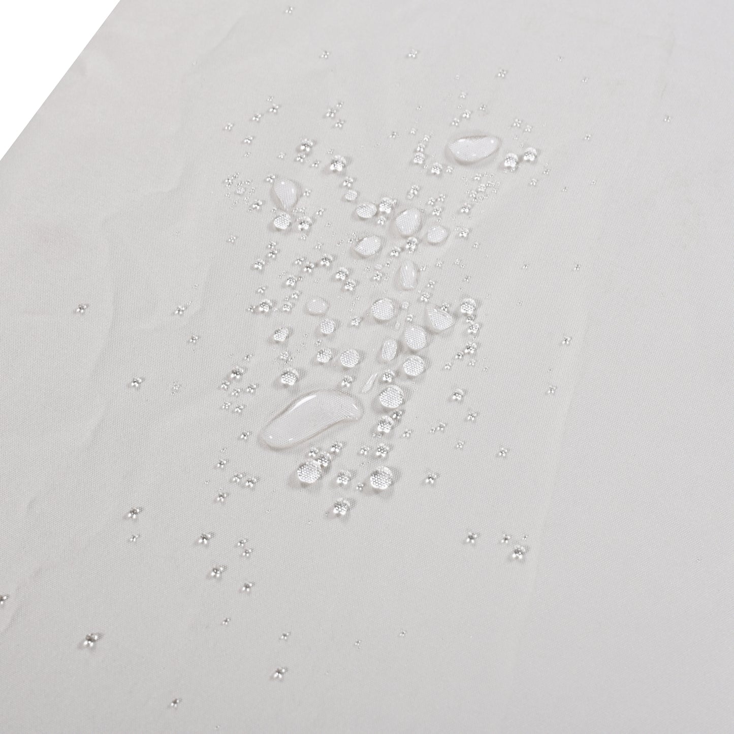 Closeup of light gray fabric with clear water droplets showcasing its waterproof quality
