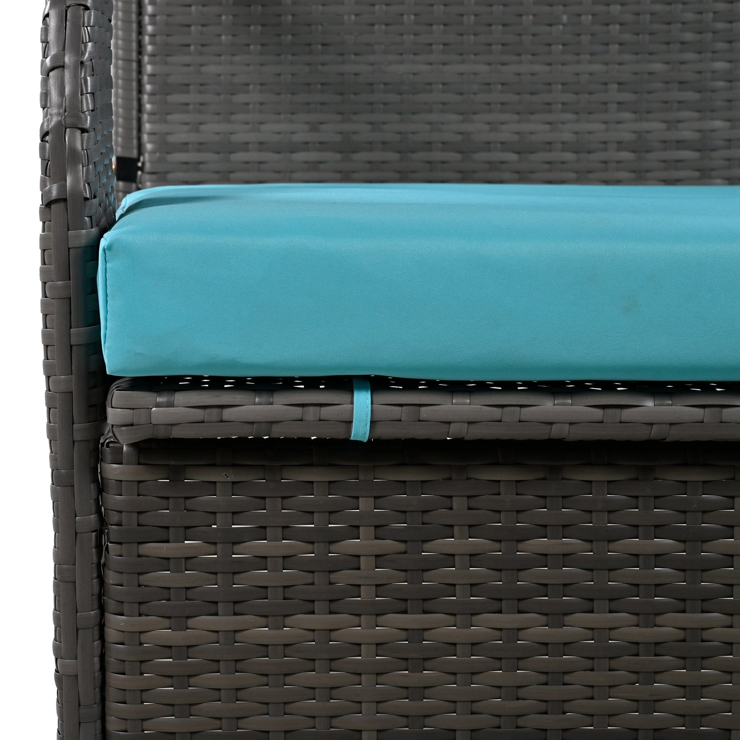 Closeup of grey wicker patio chair armrest with a teal cushion perfect for outdoor seating