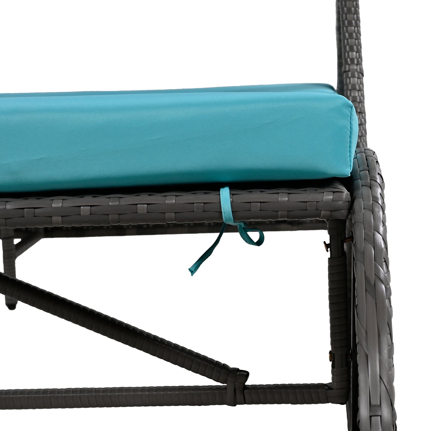 Closeup of a turquoise outdoor chaise lounge cushion tied to a dark grey wicker frame