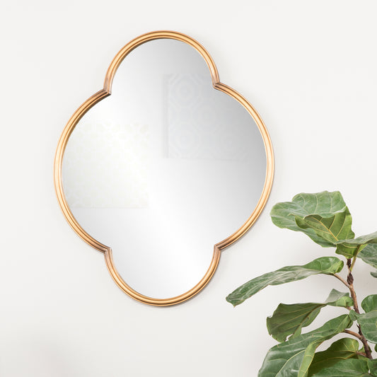 Gold quatrefoil mirror with reflective surface ideal for entryway decor