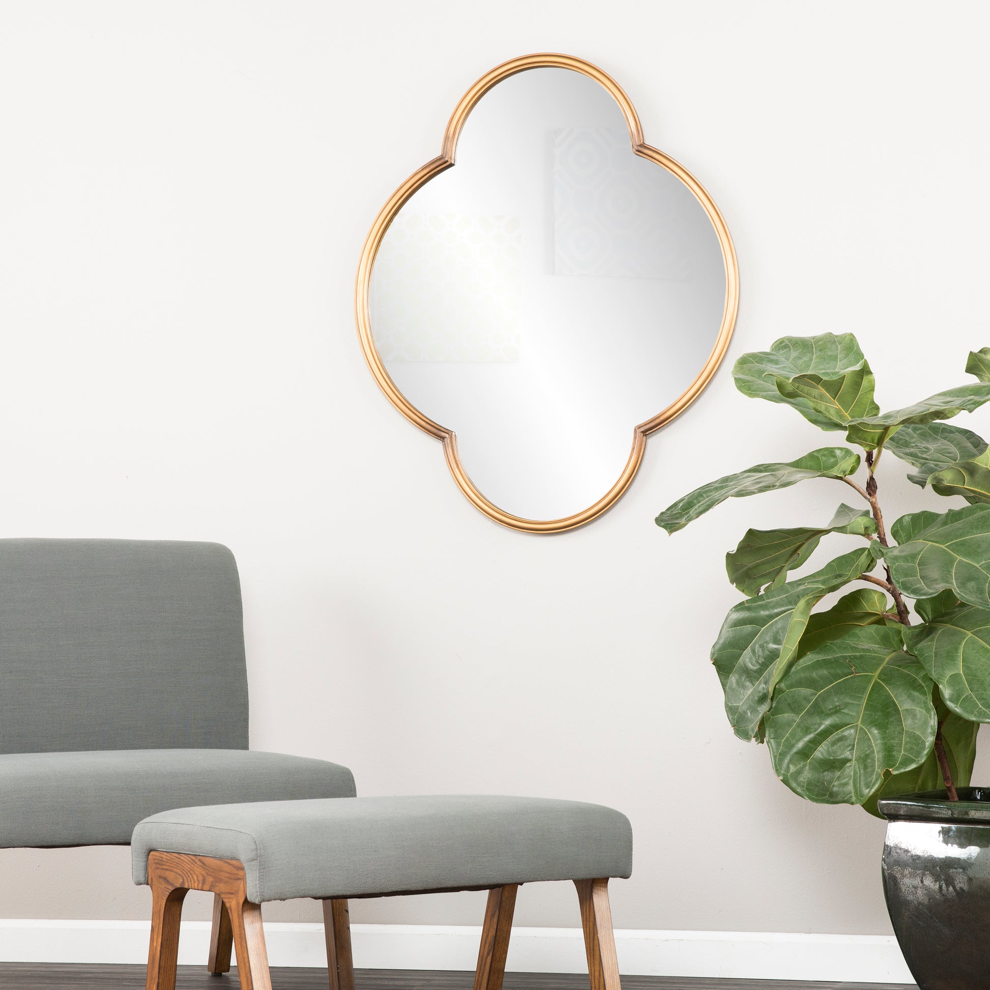Gold quatrefoil wall mirror with ornate frame perfect for entryway decor