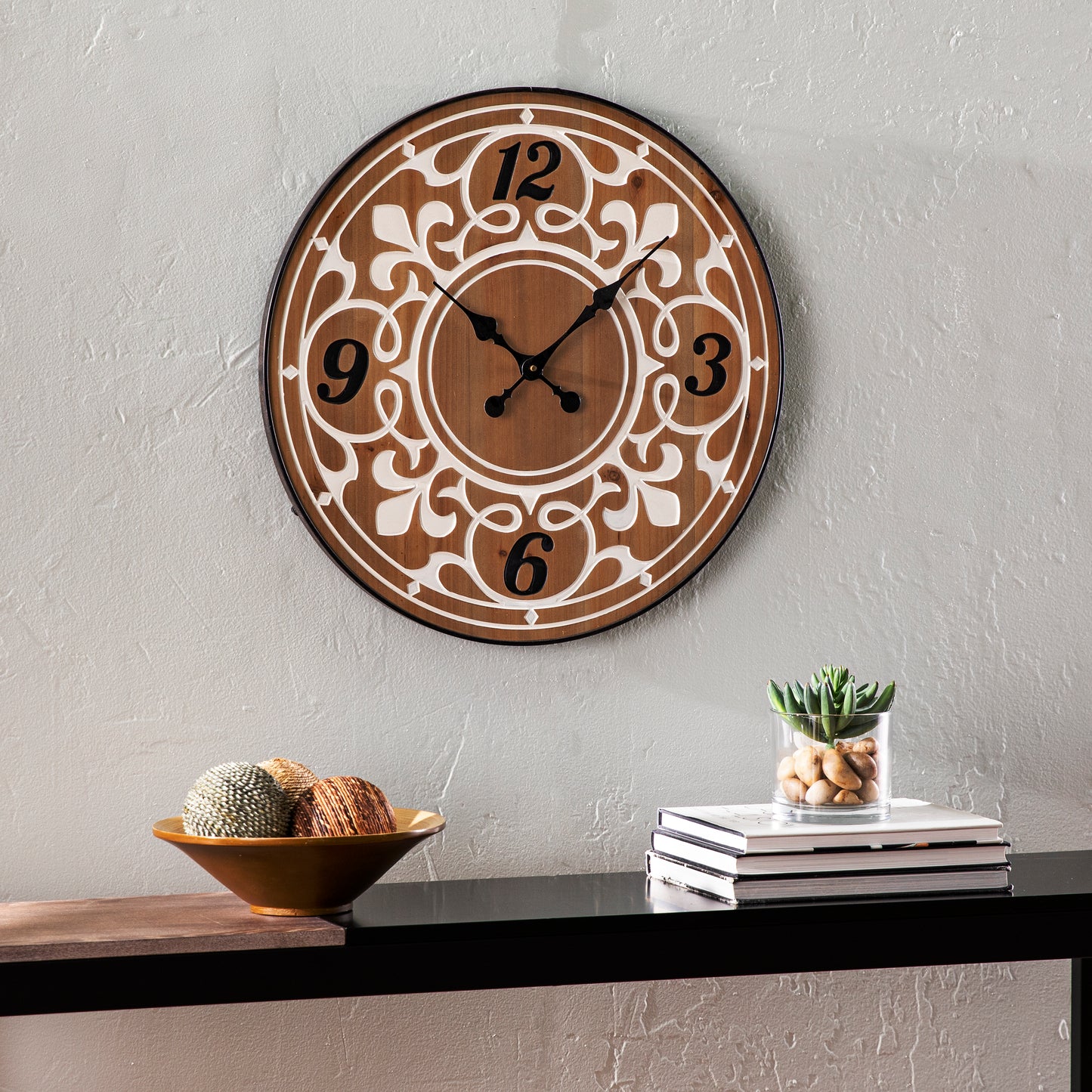 Ornate brown wood wall clock with white decorative overlay and black numerals
