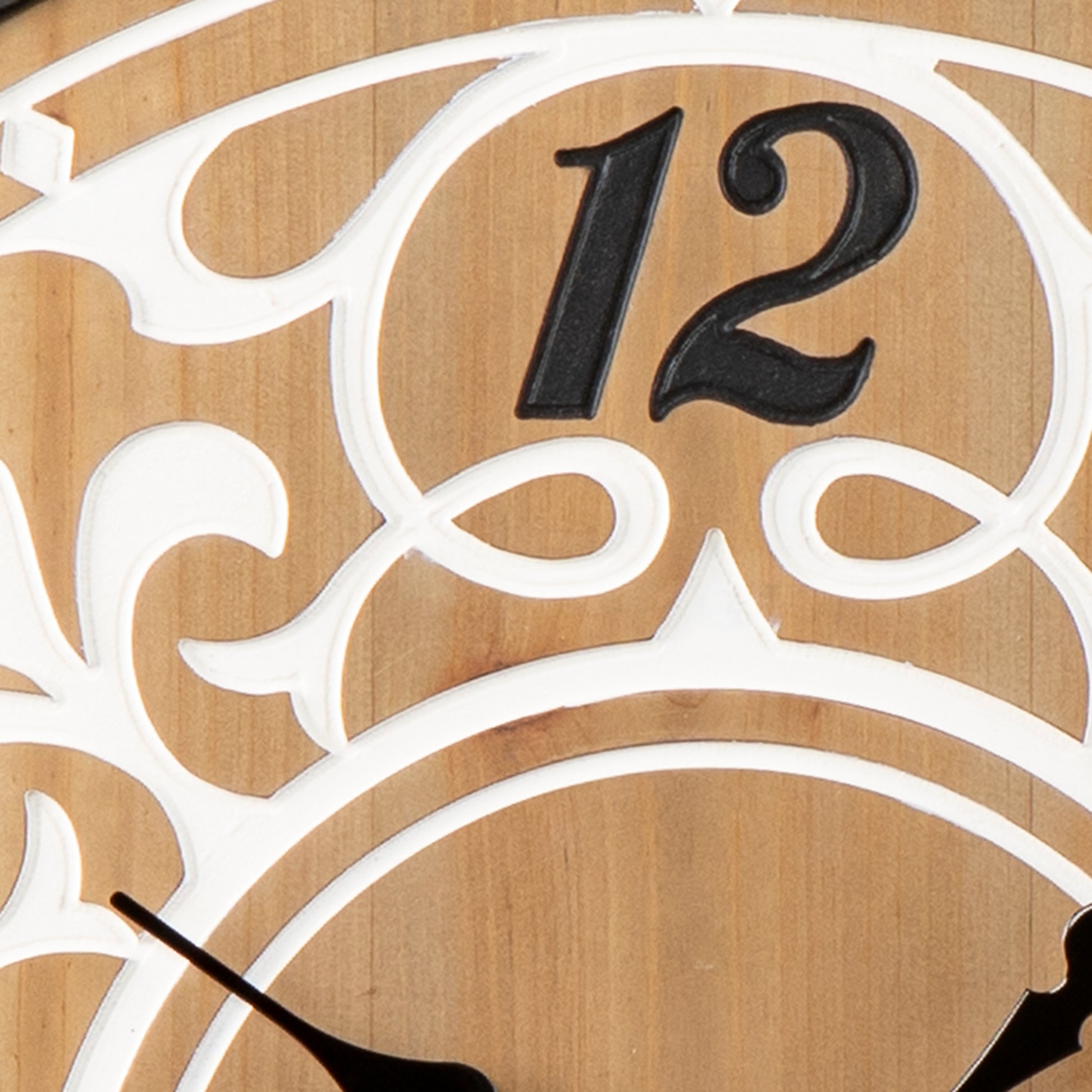 Wooden wall clock with ornate white scrollwork and black Arabic numeral
