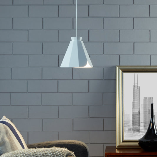 Modern white pendant light with a geometric shade casting a warm glow