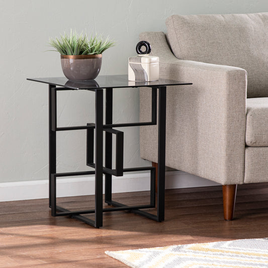 Black glass top end table with geometric metal base perfect for living rooms