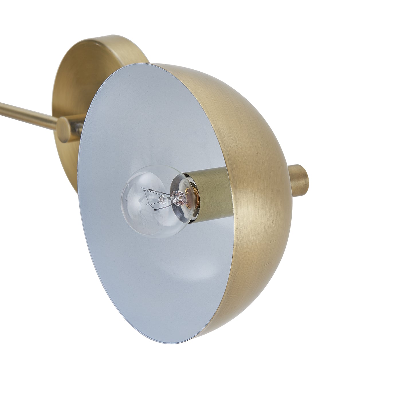 Closeup of a brushed brass wall sconce with a light bulb exposed