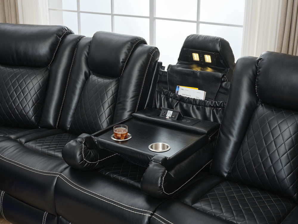 Black leather recliner sofa with diamond stitching and builtin console