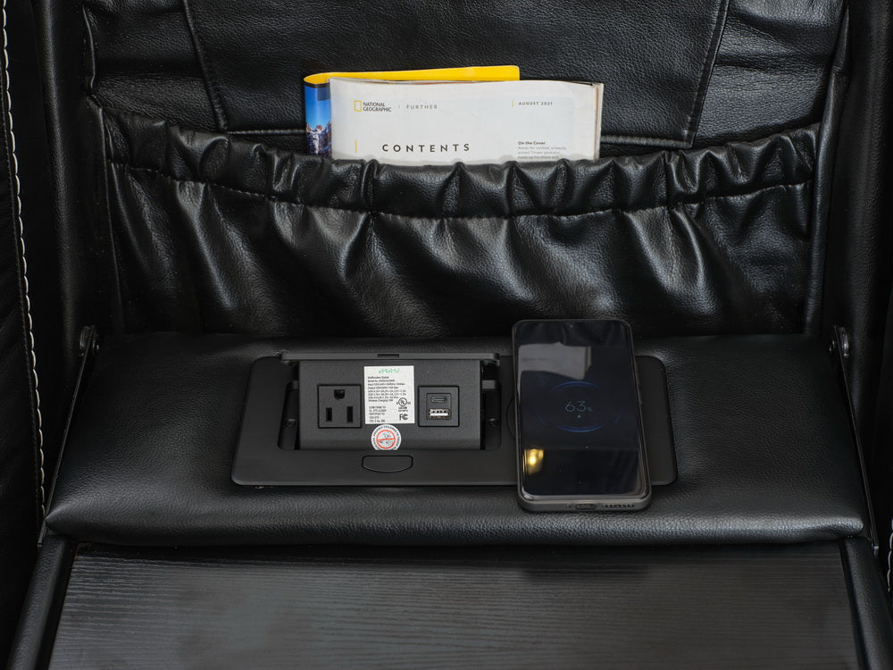 Black leather recliner with builtin power outlet and wireless charger for convenience