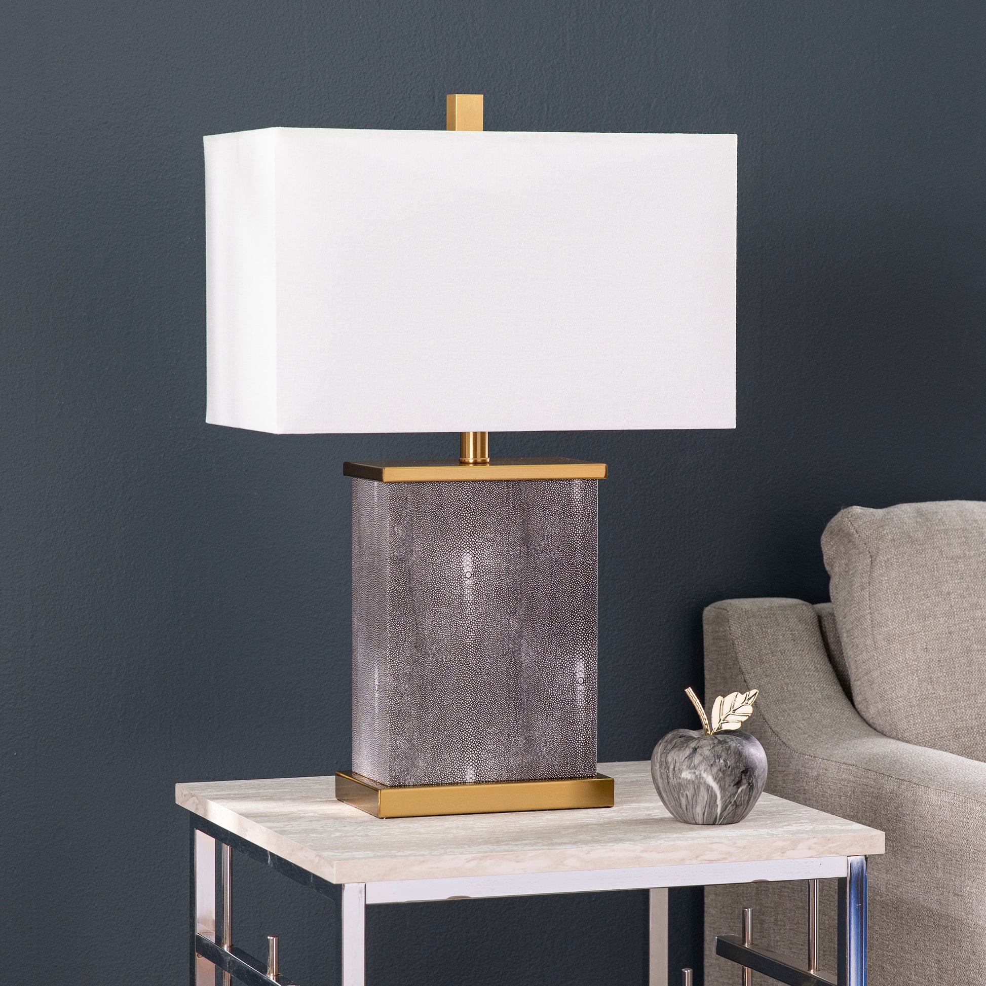 Rectangle lamp with gray textured base and white shade on end table