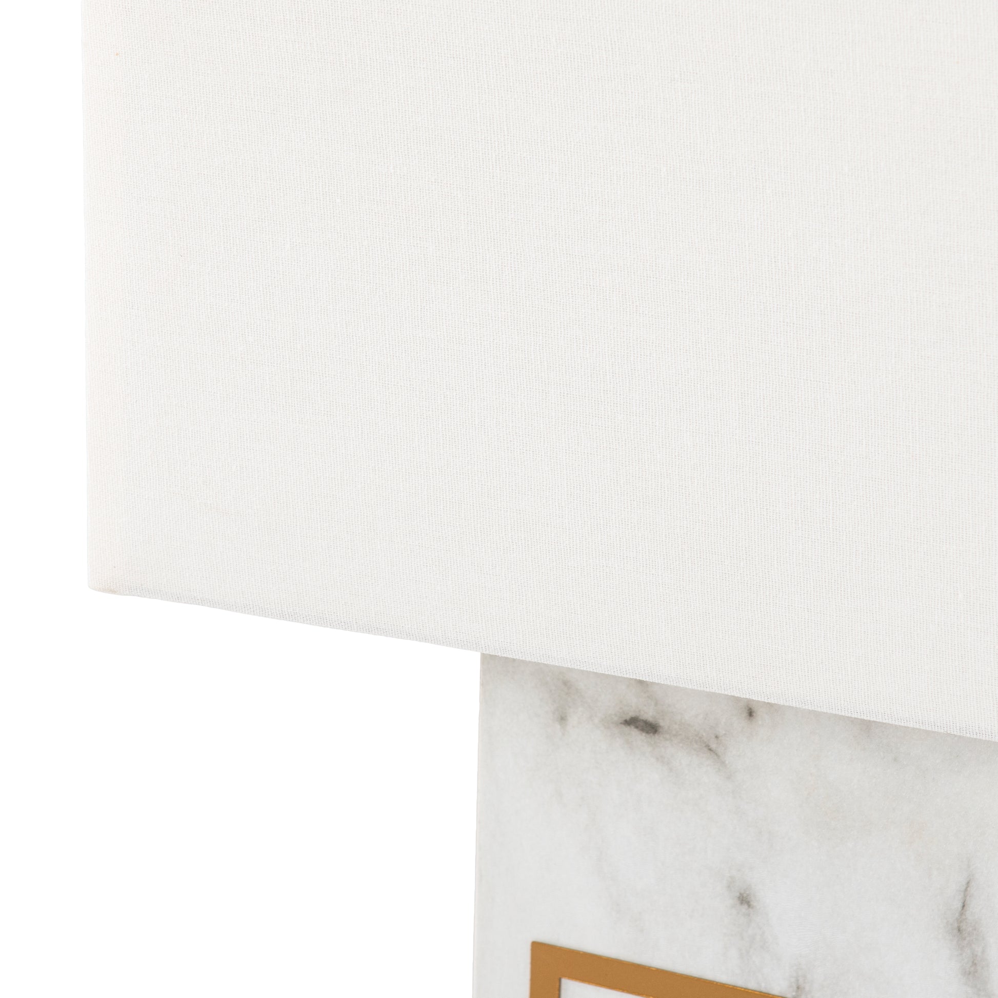 White fabric lampshade with a marble base accented with gold trim