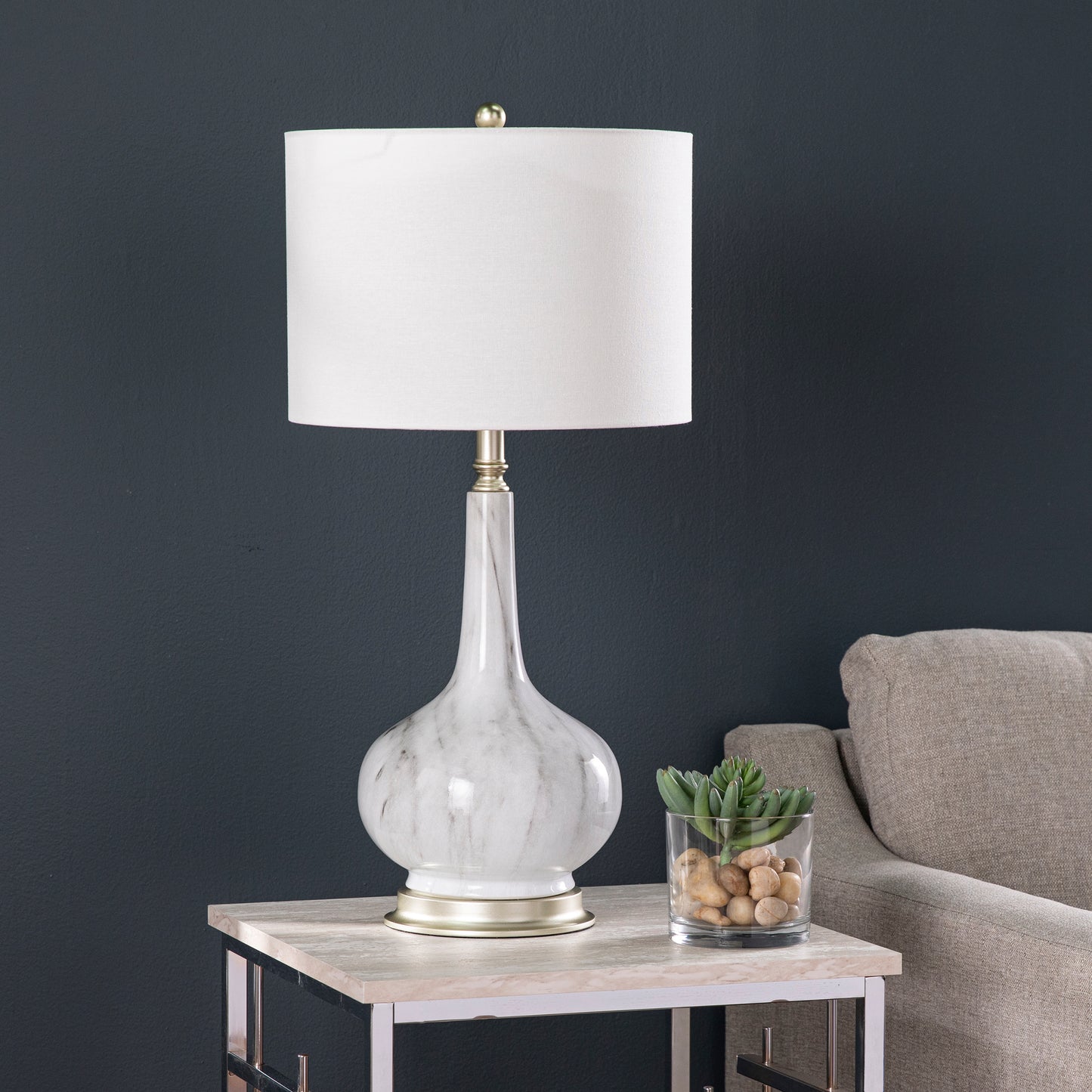 Elegant marble table lamp with a white linen shade and brushed gold base for sophisticated living rooms