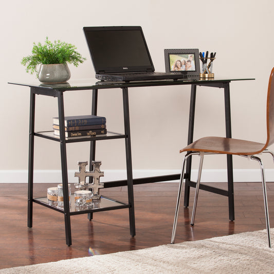 Modern glass top computer desk with black metal frame and two shelves for storage