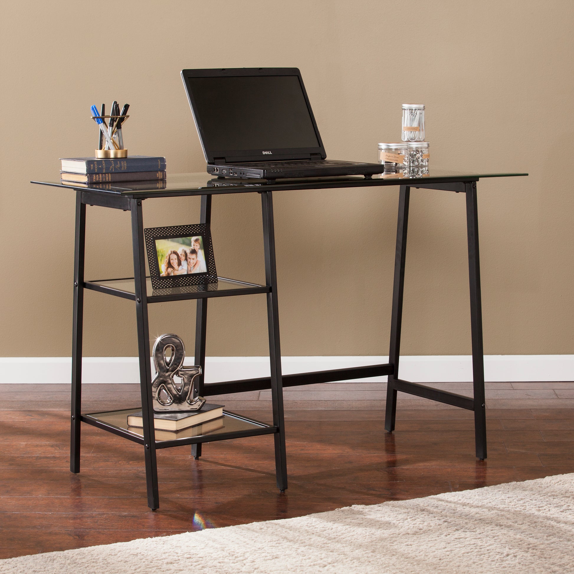 Modern glass top desk with black metal frame and two shelves perfect for home office setup