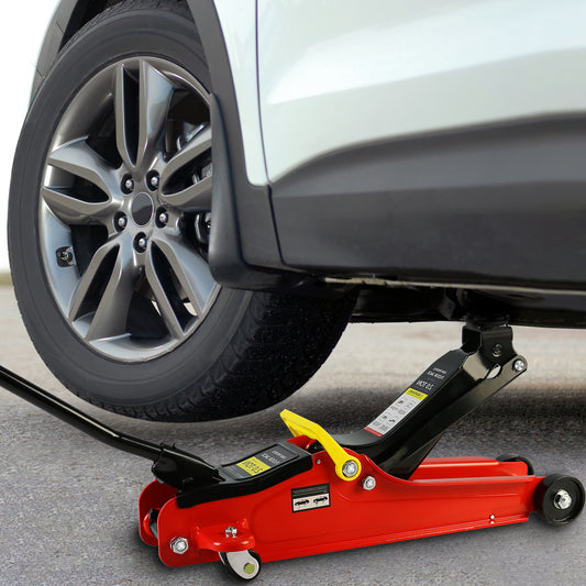 Red lowprofile floor jack with yellow handle lifting a white car