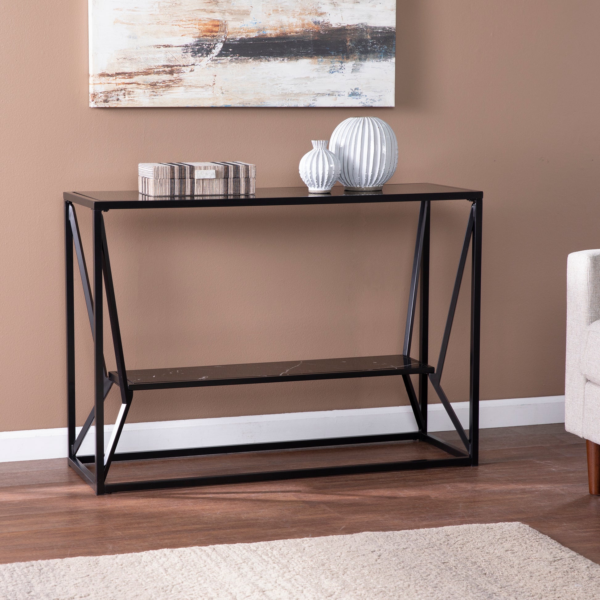 Black metal console table with glass top and faux marble shelf